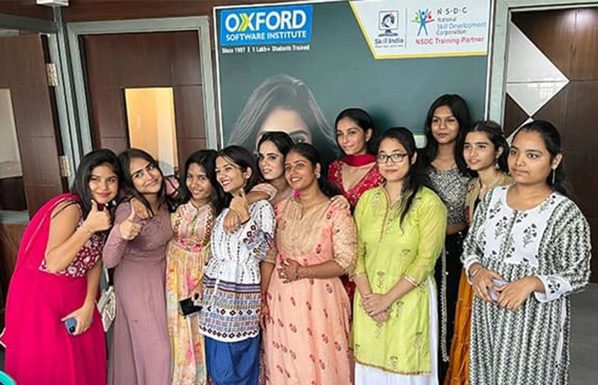 Group of female students celebrating in traditional attire at Oxford School of Accounting