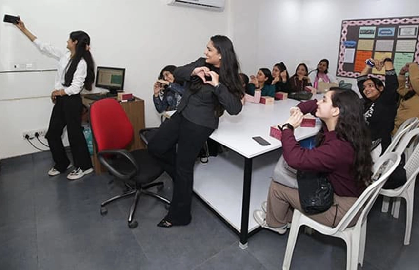 Students taking selfie and enjoying group activities in Oxford School of Accounting classroom