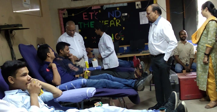 Students and staff participating in a blood donation camp