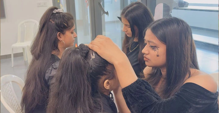 Girls helping each other with makeup before event