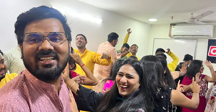 Students dancing joyfully in ethnic attire