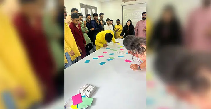 Students enjoying team game with colorful papers