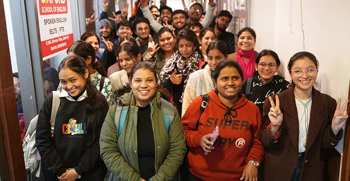 Students smiling and posing in hallway
